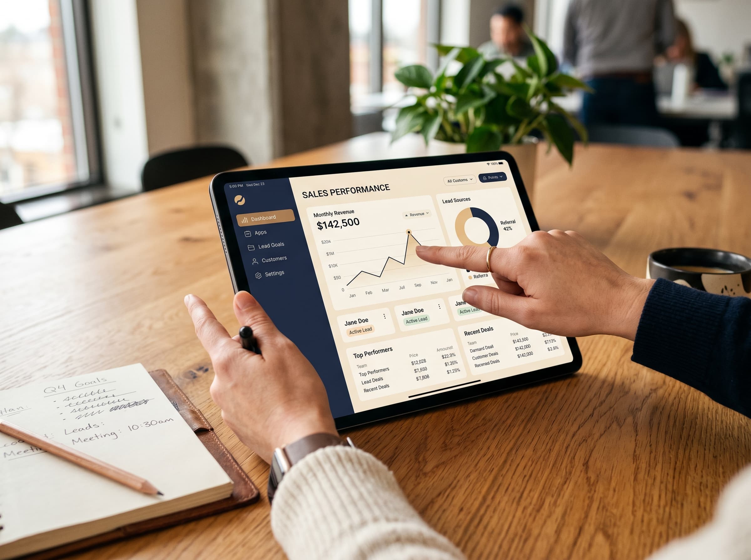 Hands working with a tablet displaying a custom business app